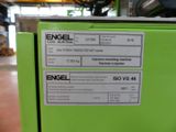 a green refrigerator with a label on it in a room
