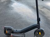 a black scooter that is sitting on the street