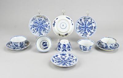 a group of blue and white china dishes and cups