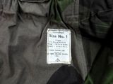 a close up of a camouflage jacket with a tag on it