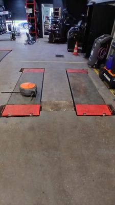 a small orange object on the floor of a garage