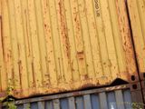 a yellow container sitting on top of a blue and yellow container
