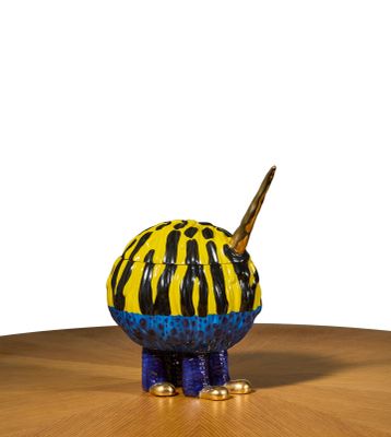 a yellow and black animal figurine sitting on a table