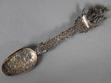 a silver spoon with a metal handle on a table