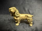 statue of a golden dog on a black background