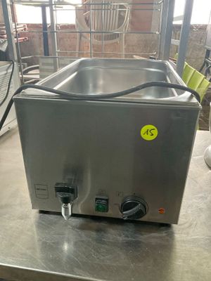 a stainless steel counter top with a sink and a faucet on it