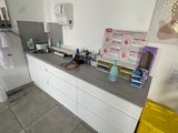 a picture of a kitchen with a refrigerator, sink, and microwave
