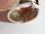 a person holding a silver ring in their hand