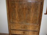a wooden cabinet with a marble top in a room
