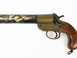 a close up of a gun with a wooden handle on a white surface
