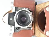 a brown leather case with a camera inside of it