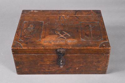 an old wooden box with carvings on the inside of it