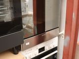 two ovens that are being installed in the kitchen