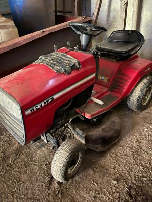 a red lawn mower parked in a garage