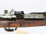 an old rifle with a wooden barrel and a metal handle