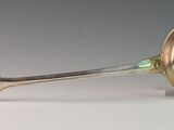 a silver spoon with a spoon handle on a table