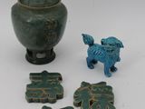 a small green vase and a small blue dog figurine