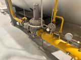 a yellow pipe and a white boat in the background