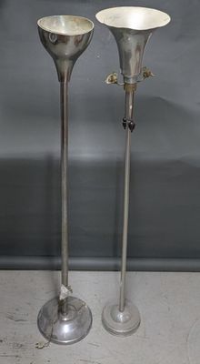 pair of silver plated candlesticks on stand on grey background