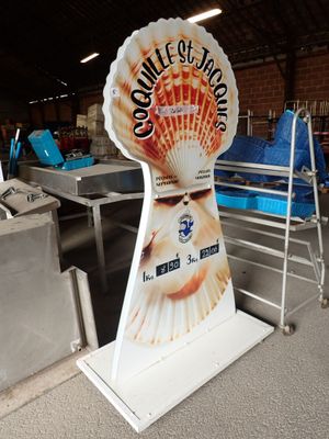 a sign for a seafood restaurant in the middle of a factory