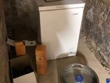 an image of a small room with a sink and a refrigerator
