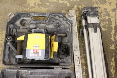 a yellow and black laser level in a plastic case