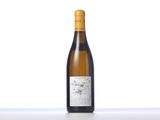 a bottle of white wine sitting on top of a table