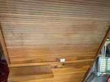 a wooden desk with a drawer underneath it in a room