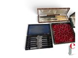 a box with a knife and a set of pens in it