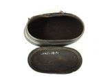 a small black box with writing on it on a white surface