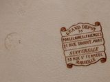 a close up of a plate with a sign on it