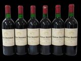six bottles of wine are lined up in a row on a black background
