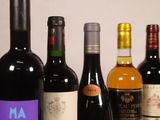 several bottles of wine are lined up on a table