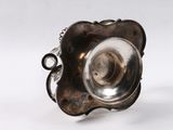 an antique silver plated ring with a flower design on it