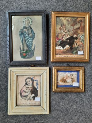 three framed pictures of a woman and a cat are on a wall