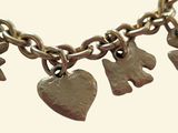 a close up of a chain with charms on it