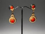 a pair of coral and pearl earrings