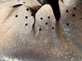 a close up of a metal object with holes in it