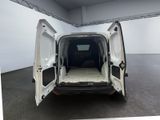 the back of a white van with its doors open in a room