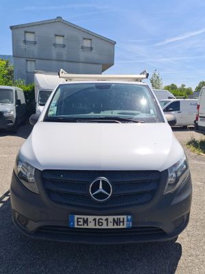 the white van is parked in the parking lot next to other vehicles