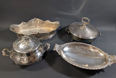 four pieces of silverware sitting on a table with a black background
