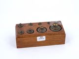 a small wooden box with buttons on it on a white surface