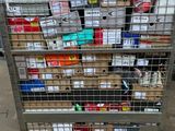 a metal cart with many boxes on it in a warehouse