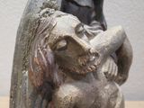 a statue of a woman holding a baby in her arms