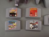 four nintendo game cartridges sitting on top of a table next to a mouse