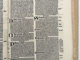 an open book with a black and white image of a cross on it