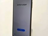 a close up of a cell phone on a stand on a white surface