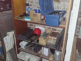 a shelf with tools on it in the corner of a room