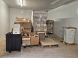 many boxes and pallets in a room with a lot of boxes