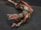 a statue of a lizard that is laying on the ground